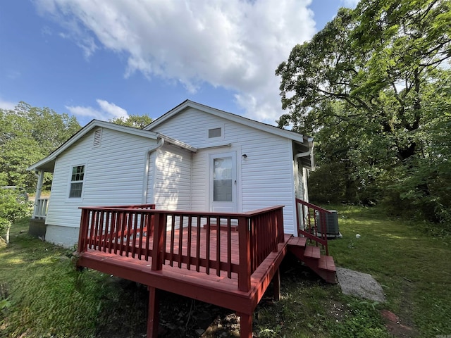 back of house featuring central air condition unit, a yard, and a deck