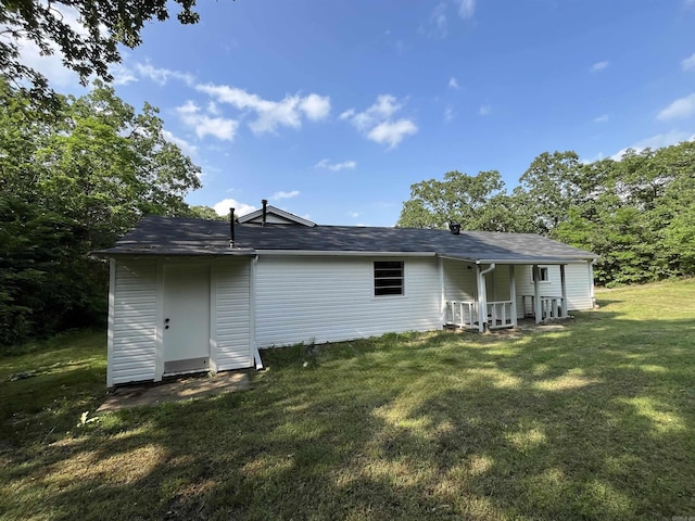 rear view of property with a yard