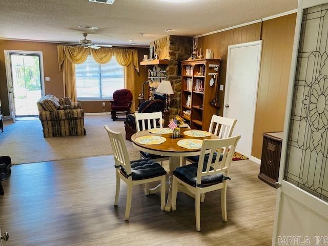 dining room with light hardwood / wood-style flooring, ornamental molding, and ceiling fan