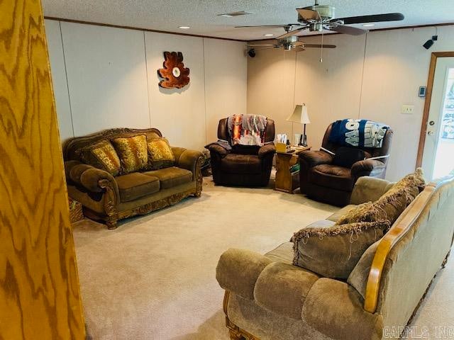 living room featuring ceiling fan, light carpet, and a textured ceiling