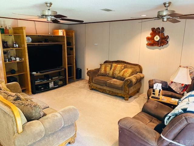 living room with carpet and ceiling fan