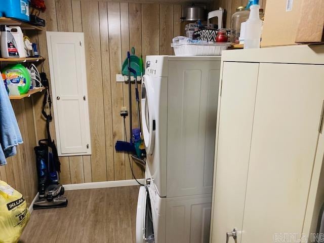 laundry room with cabinets, hardwood / wood-style floors, and wooden walls