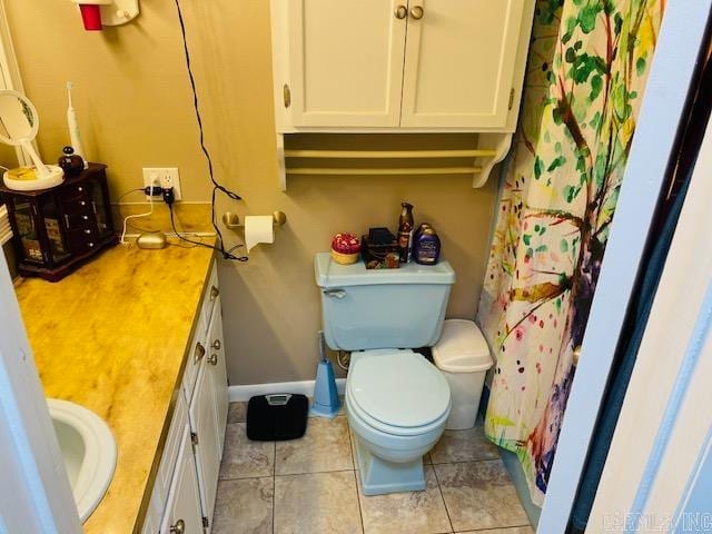 bathroom featuring toilet, vanity, a shower with shower curtain, and tile patterned flooring