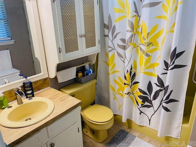 bathroom featuring vanity, tile patterned floors, toilet, and walk in shower