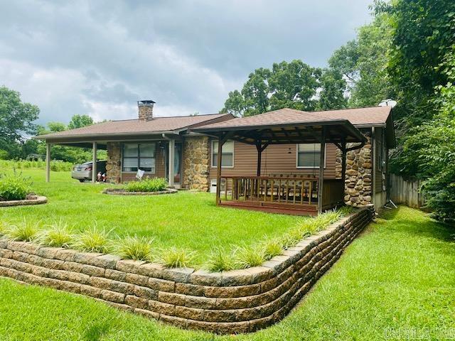 back of house with a yard and a carport