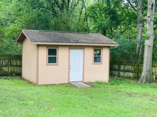 view of outbuilding with a yard