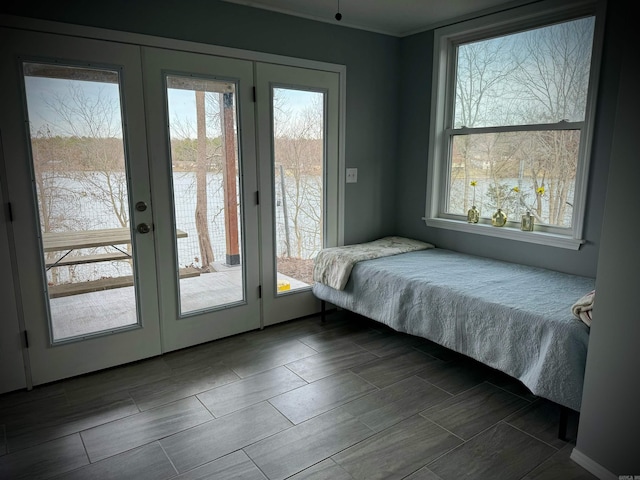 tiled bedroom with access to outside, french doors, and multiple windows