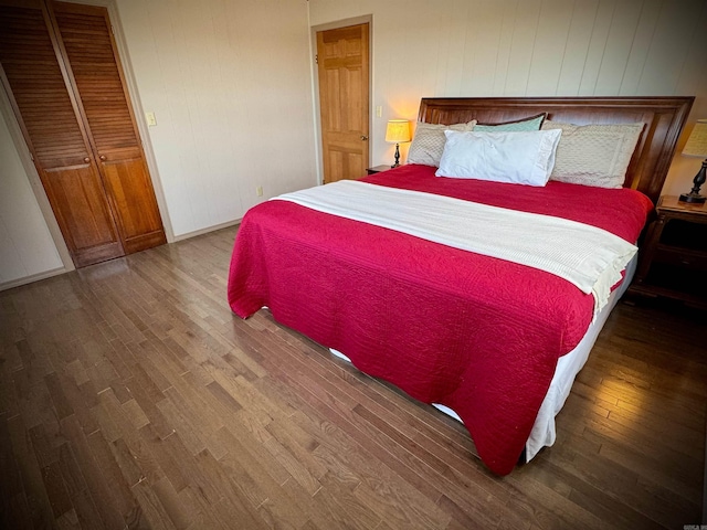 bedroom with a closet and dark wood-type flooring