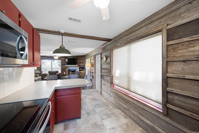 170 Ridge Rd, Houston, AR 72720 - kitchen with visible vents, a ceiling fan, stainless steel microwave, and red cabinets