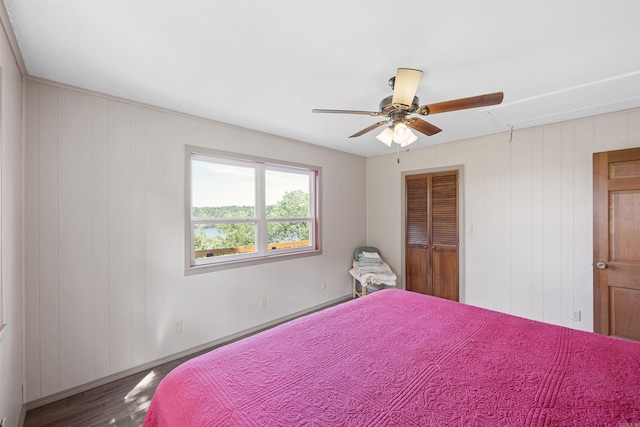 170 Ridge Rd, Houston, AR 72720 - bedroom featuring ceiling fan, attic access, wood finished floors, baseboards, and wooden walls