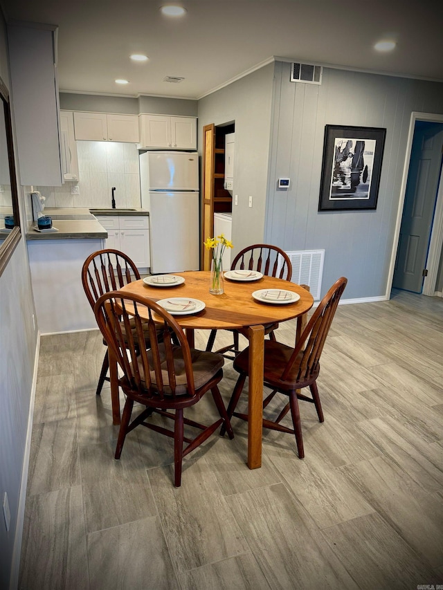 dining space with light hardwood / wood-style floors