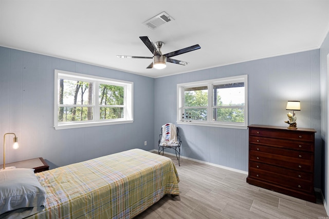 bedroom with multiple windows and ceiling fan