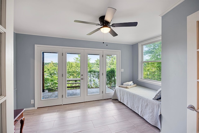 tiled bedroom with ceiling fan, french doors, and access to outside