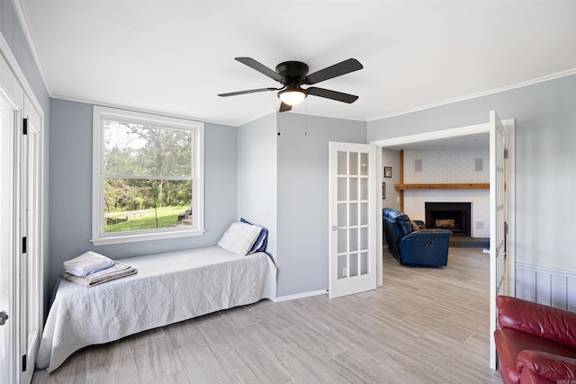 170 Ridge Rd, Houston, AR 72720 - bedroom with crown molding, a brick fireplace, wood finished floors, and ceiling fan