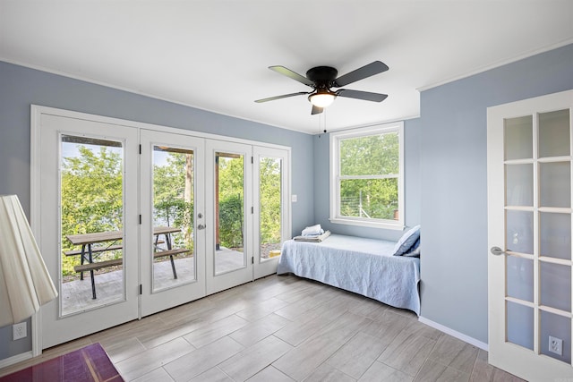 bedroom featuring ceiling fan, french doors, multiple windows, and access to exterior