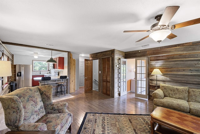 170 Ridge Rd, Houston, AR 72720 - living area featuring a ceiling fan, french doors, visible vents, wood finished floors, and wooden walls
