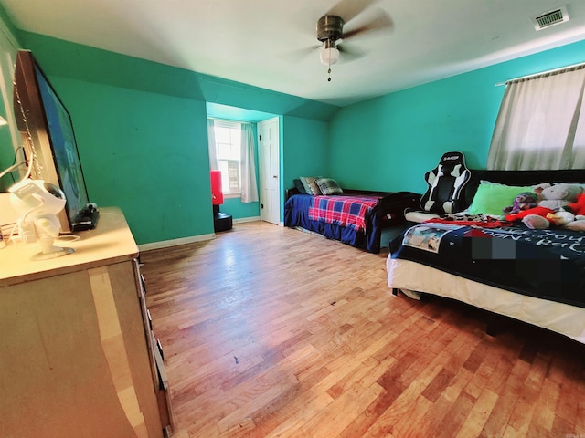 bedroom with ceiling fan and light hardwood / wood-style floors