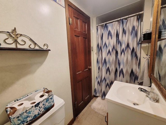 bathroom with tile patterned floors, toilet, curtained shower, and vanity