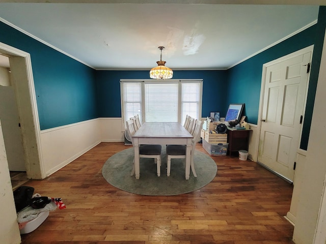 dining space with ornamental molding and wood-type flooring