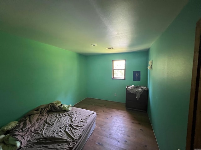 bedroom with hardwood / wood-style flooring