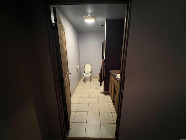 bathroom featuring vanity, tile patterned floors, and toilet