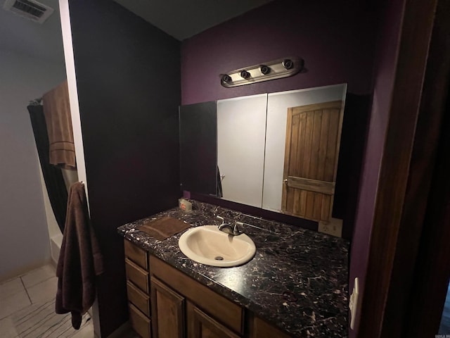 bathroom featuring a tub, vanity, and tile patterned floors