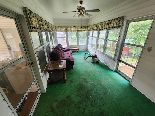 sunroom / solarium featuring plenty of natural light and ceiling fan