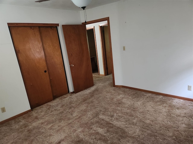 unfurnished bedroom featuring ceiling fan and carpet