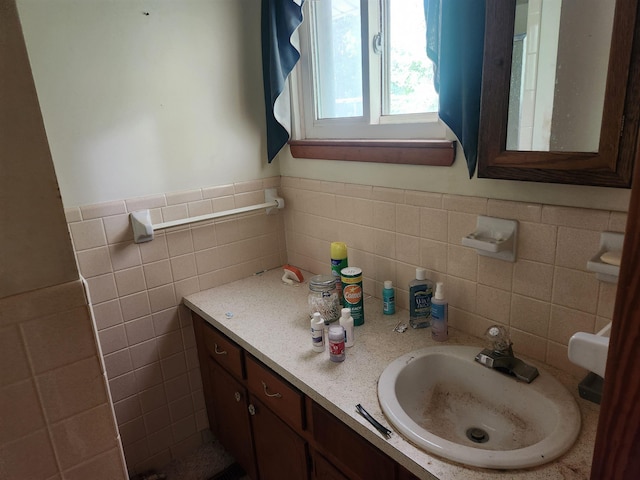 bathroom with vanity and tile walls