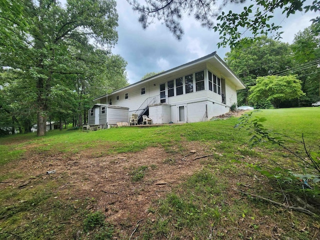 back of house with a lawn