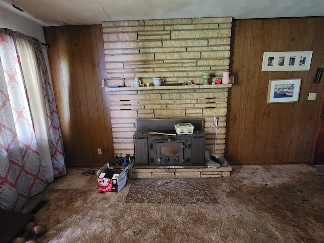 living room with a wood stove and wooden walls