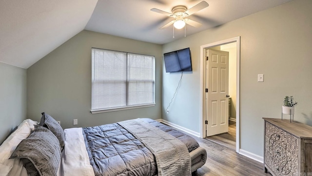 bedroom featuring ceiling fan, wood-type flooring, and vaulted ceiling