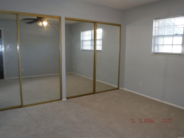 unfurnished bedroom featuring carpet floors and multiple windows