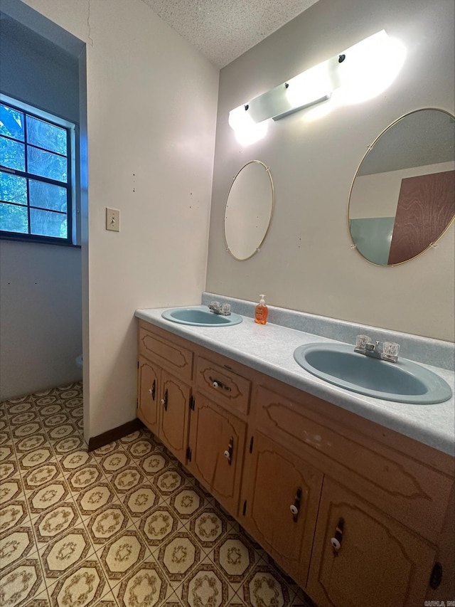 bathroom with vanity and a textured ceiling