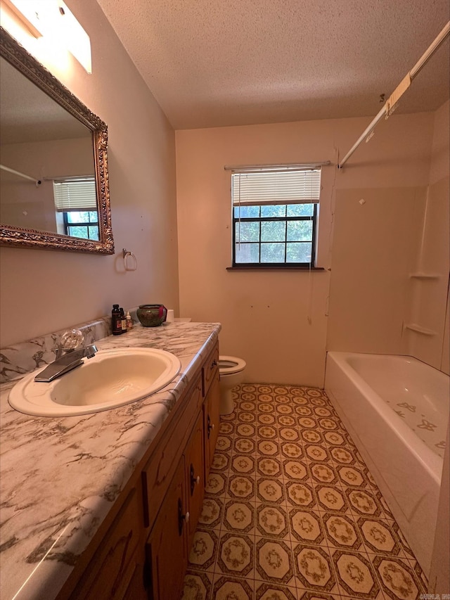 full bathroom featuring vanity, toilet, shower / bath combination, and a textured ceiling