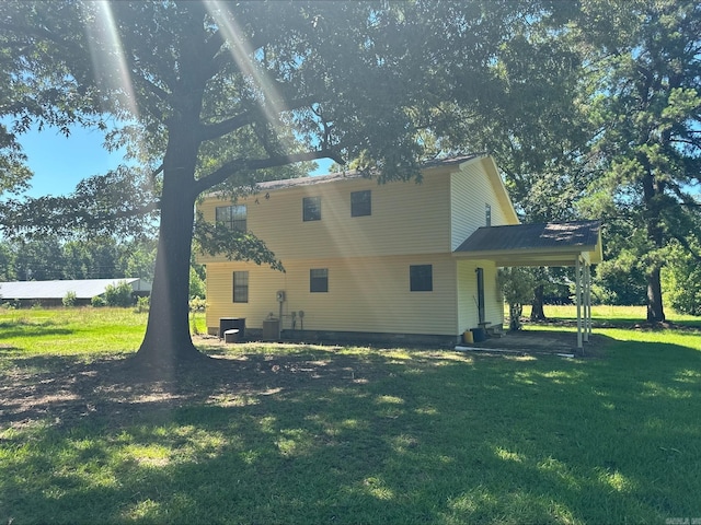 view of side of property featuring cooling unit and a lawn