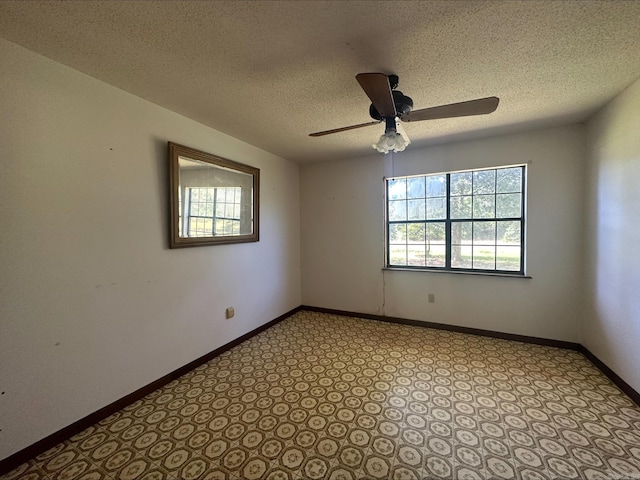 unfurnished room with a textured ceiling, light colored carpet, and ceiling fan