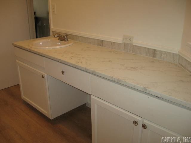 bathroom with vanity and hardwood / wood-style flooring