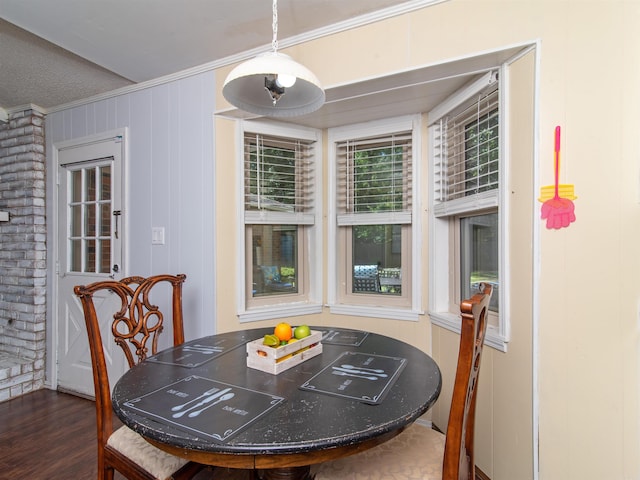 dining space featuring dark hardwood / wood-style floors and ornamental molding