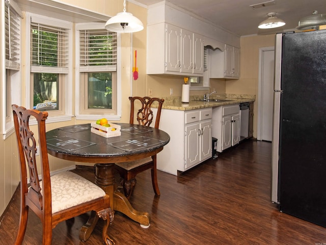 kitchen featuring white cabinets, sink, decorative light fixtures, dark hardwood / wood-style flooring, and stainless steel appliances