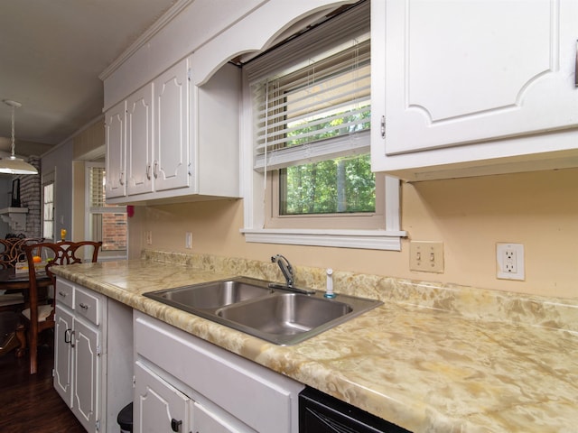 kitchen featuring white cabinetry, sink, and ornamental molding