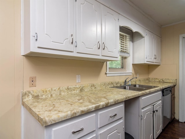 kitchen with white cabinetry, sink, stainless steel dishwasher, and ornamental molding