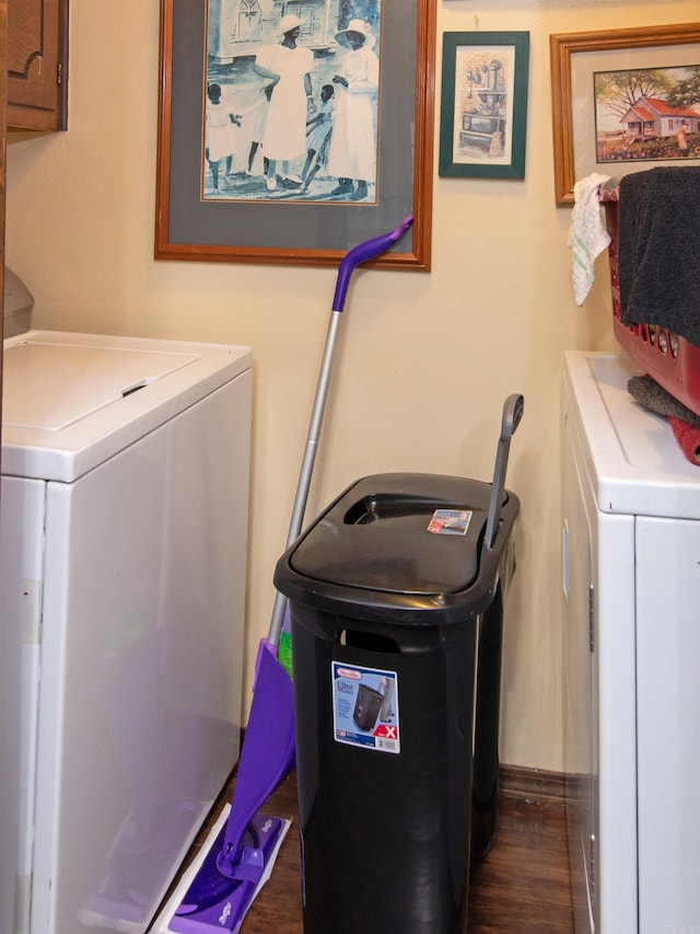 washroom featuring cabinets, dark hardwood / wood-style flooring, and washing machine and dryer