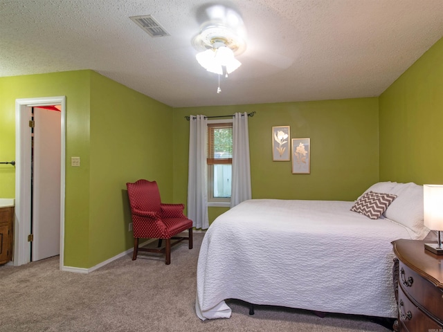 bedroom with light carpet, a textured ceiling, and ceiling fan