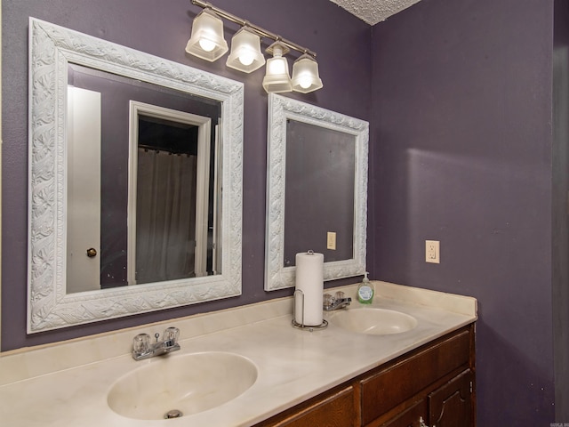 bathroom with vanity and a textured ceiling