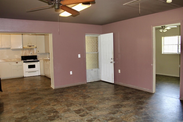 interior space featuring attic access, baseboards, and ceiling fan