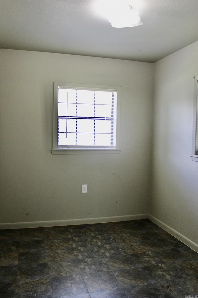 spare room featuring baseboards