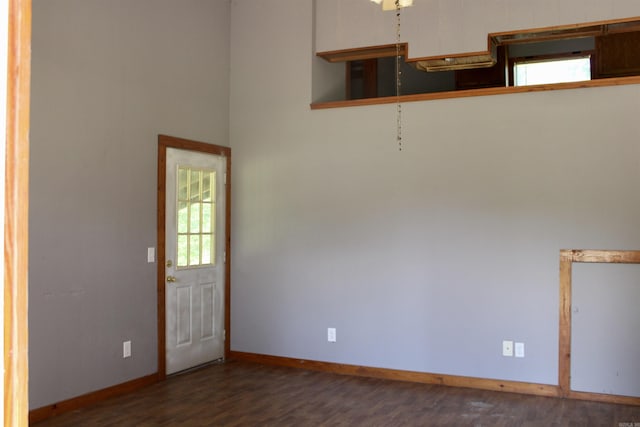 unfurnished room featuring wood finished floors and baseboards