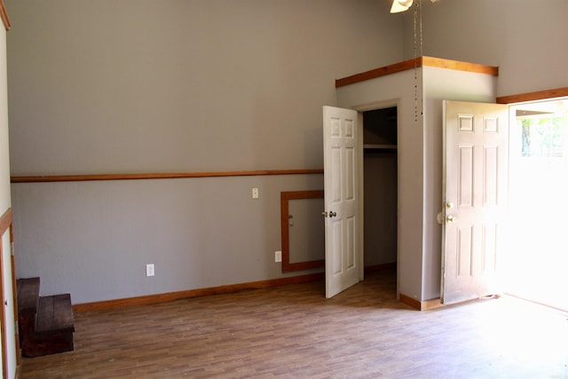 unfurnished bedroom with baseboards and wood finished floors