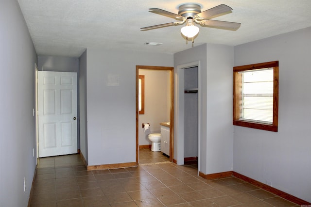 unfurnished bedroom featuring baseboards, a textured ceiling, and tile patterned floors